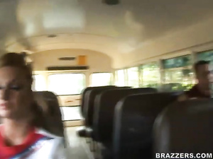 Strong guys are enjoying foursome with two busty schoolgirls wearing red uniform. They are banging them hard in the school bus.